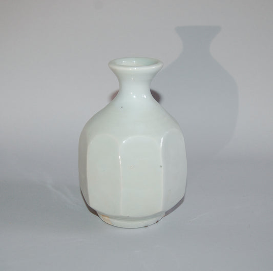 Octagonal tokkuri sake bottle, porcelain with facets, white glaze on porcelain, by Kato Kiyonobu, Japan