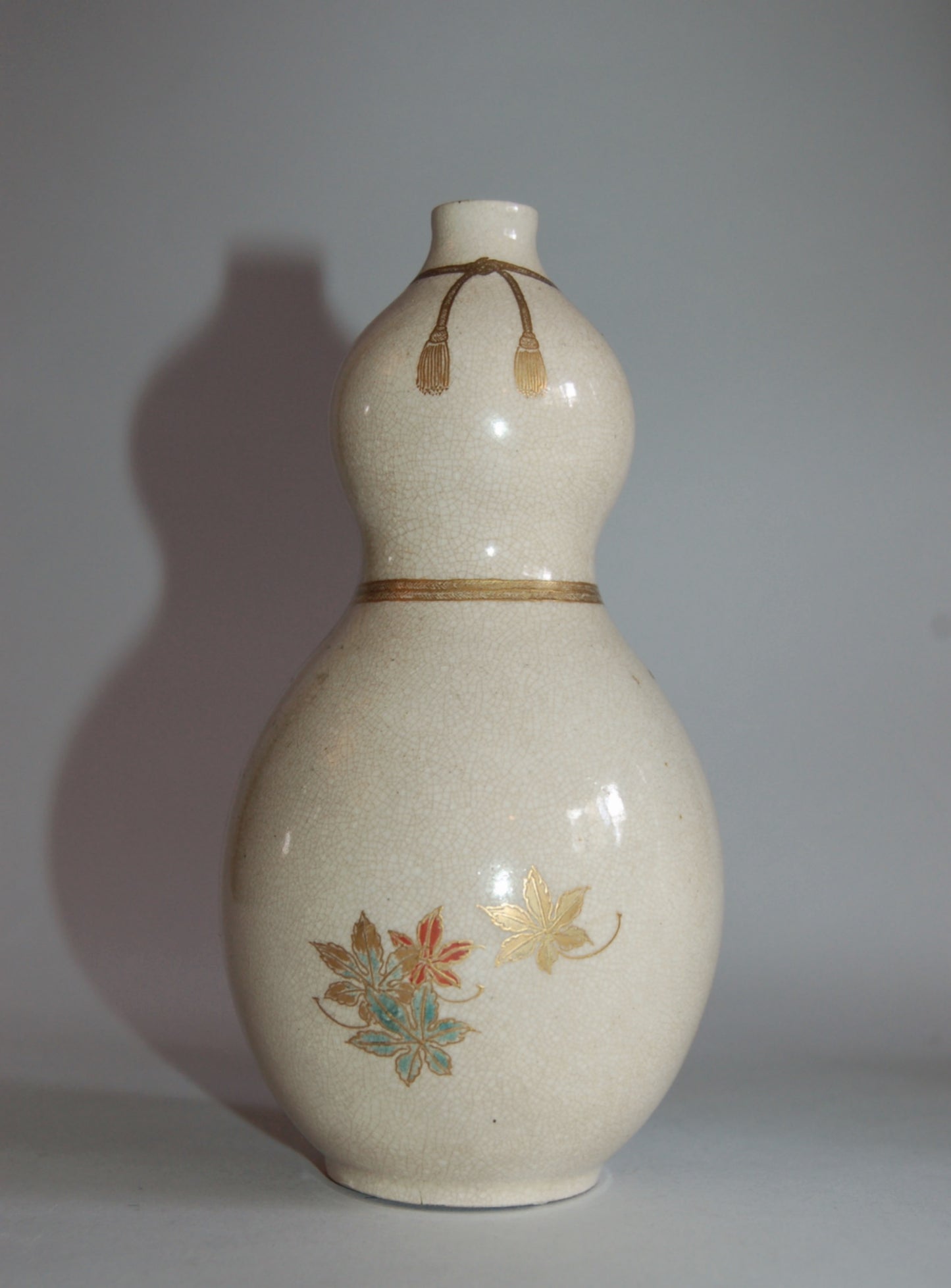 Gourd flask, maple leaves on stream, golden cords and tassels, Kyoto ware, Japan