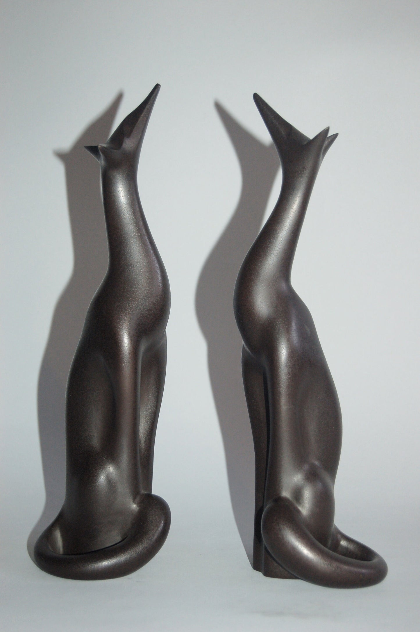 Pair of stylized moon gazing foxes, brown patinated bronze, by Sakai Kozan, Japan